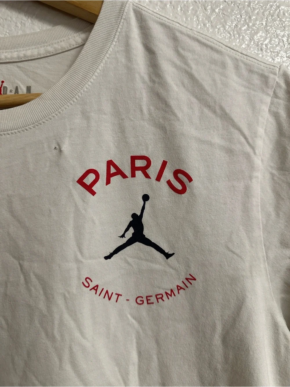 Jordan Paris Saint-Germain Cream Graphic Tee with Red and Black Logo